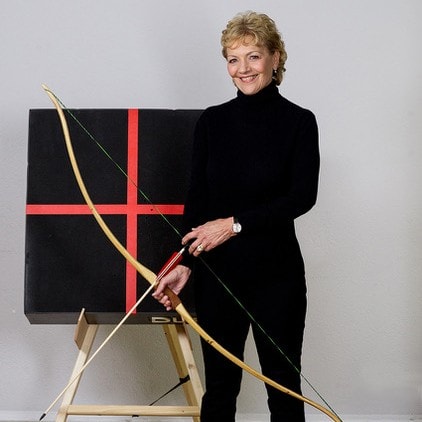Renate Starke with her longbow beside the target